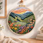 Mountain wildflower valley embroidery hoop wall art displayed as warm and cozy handmade home decor
