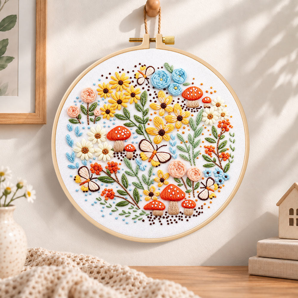 Mushroom and butterfly garden embroidery hoop wall art displayed as warm and cosy handmade home decor