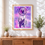 Finished mystical galaxy dreamcatcher with purple butterfly cross stitch artwork displayed