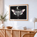 Mystical moth with moon and stars cross stitch artwork displayed on wall as home decor