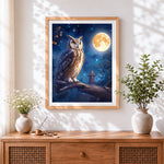 Finished mystical owl perched under a full moon cross stitch artwork displayed