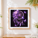 Finished mystical purple butterfly dreamcatcher cross stitch artwork displayed