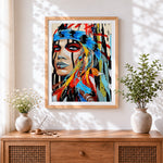 Finished native american style feather portrait cross stitch artwork displayed