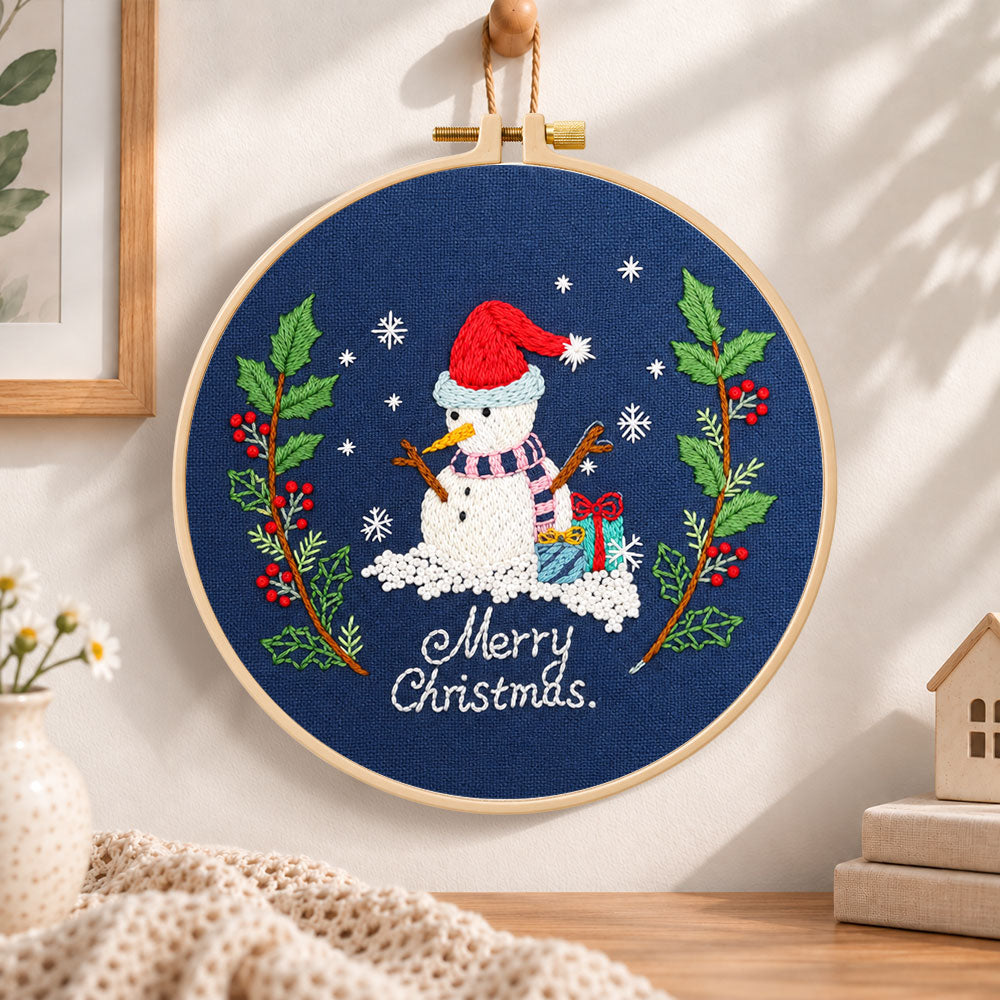 Navy snowman art embroidery hoop wall art displayed as warm and cosy handmade home decor