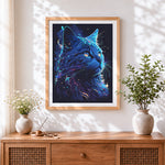 Finished neon blue cosmic cat cross stitch artwork displayed