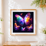 Finished neon glowing butterflies cross stitch artwork displayed