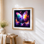 Neon glowing butterflies cross stitch artwork displayed on wall as home decor
