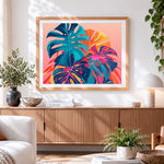 Finished neon monstera leaves cross stitch artwork displayed