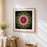 Neon pink and green kaleidoscope mandala cross stitch artwork displayed on wall as home decor