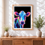 Finished neon pop art cow in the dark cross stitch artwork displayed