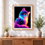 Finished neon rainbow cat in the dark cross stitch artwork displayed