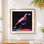 Finished neon splatter crow on black background cross stitch artwork displayed