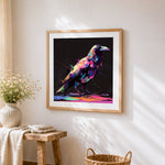 Neon splatter crow on black background cross stitch artwork displayed on wall as home decor