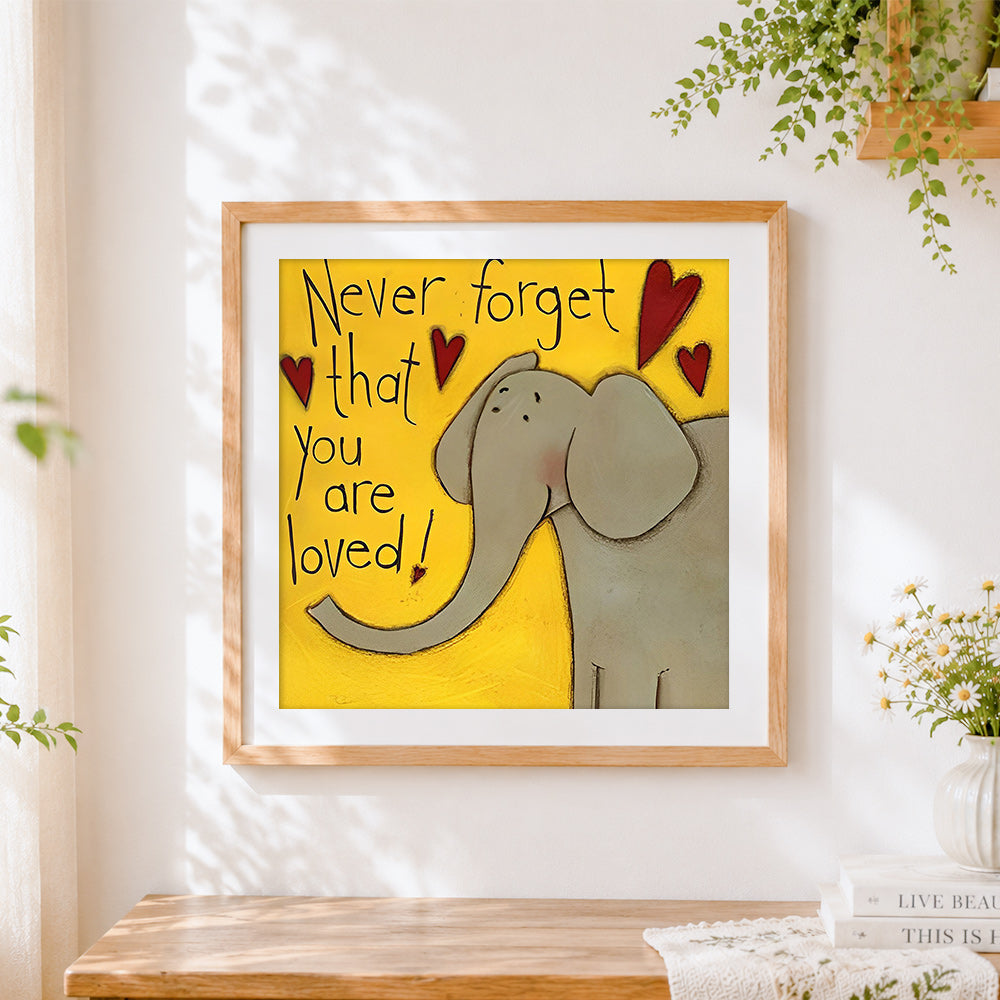Finished "never forget that you are loved" elephant cross stitch artwork displayed