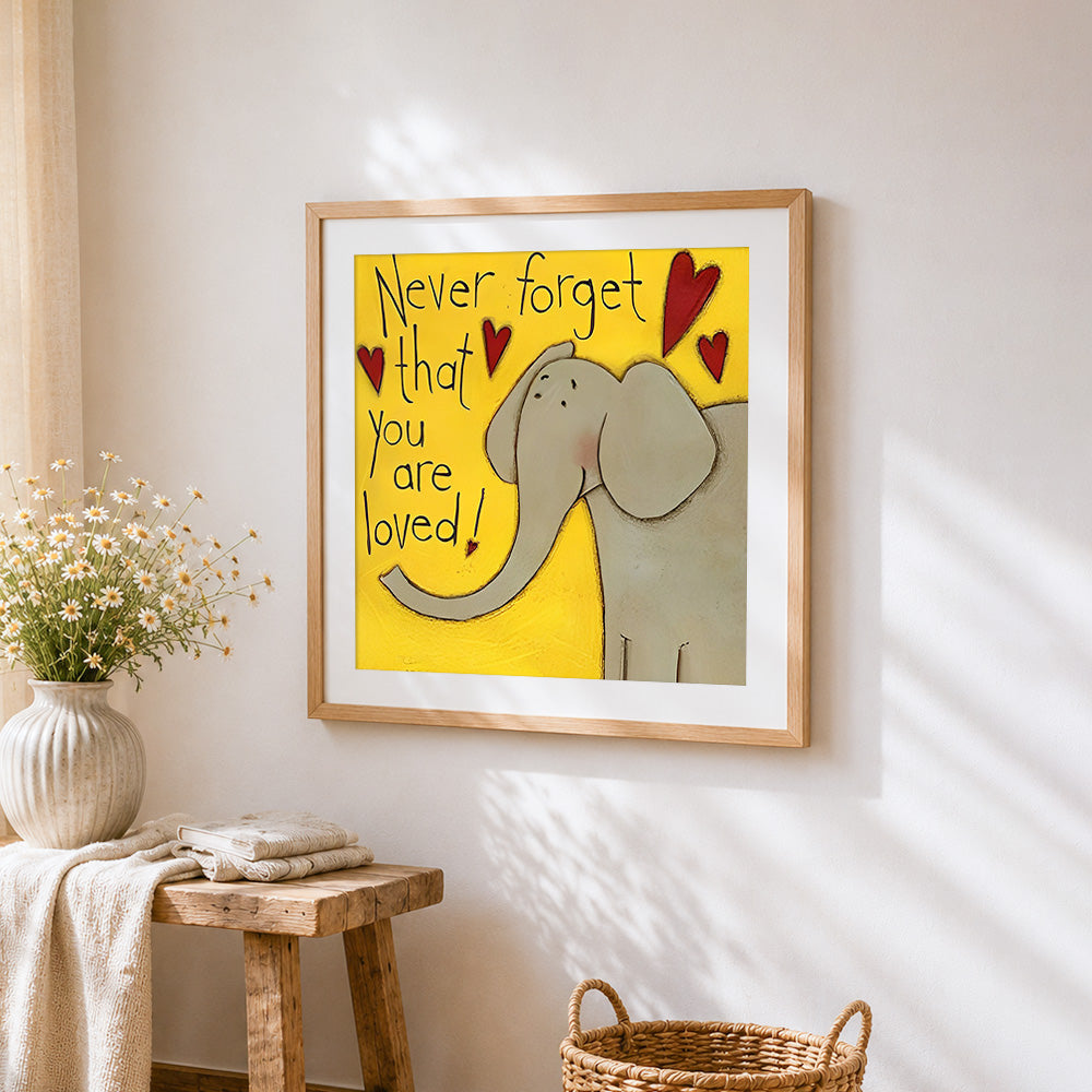 "Never forget that you are loved" elephant cross stitch artwork displayed on wall as home decor