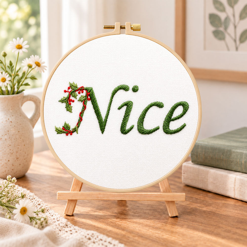 Nice holly lettering embroidery kit finished hoop displayed on a wooden stand as cozy tabletop decor
