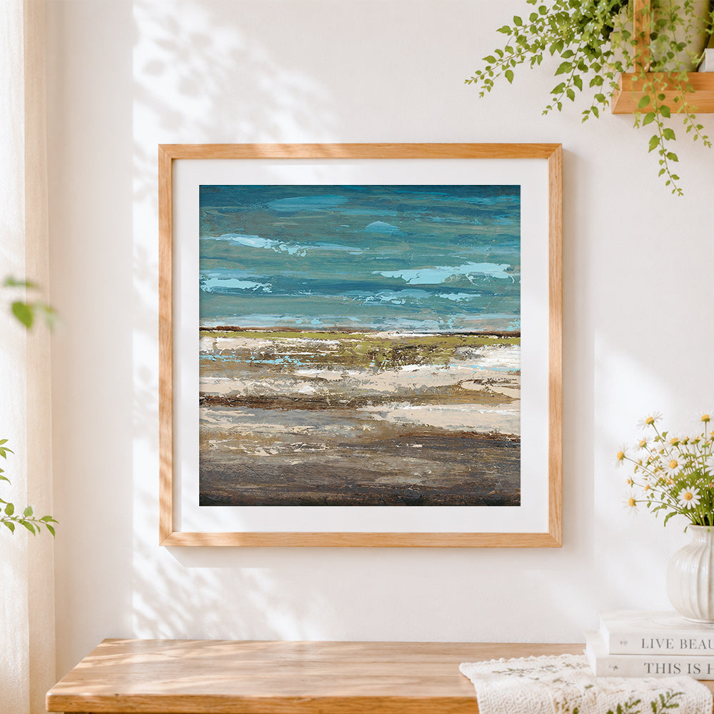 Finished ocean and shore cross stitch artwork displayed