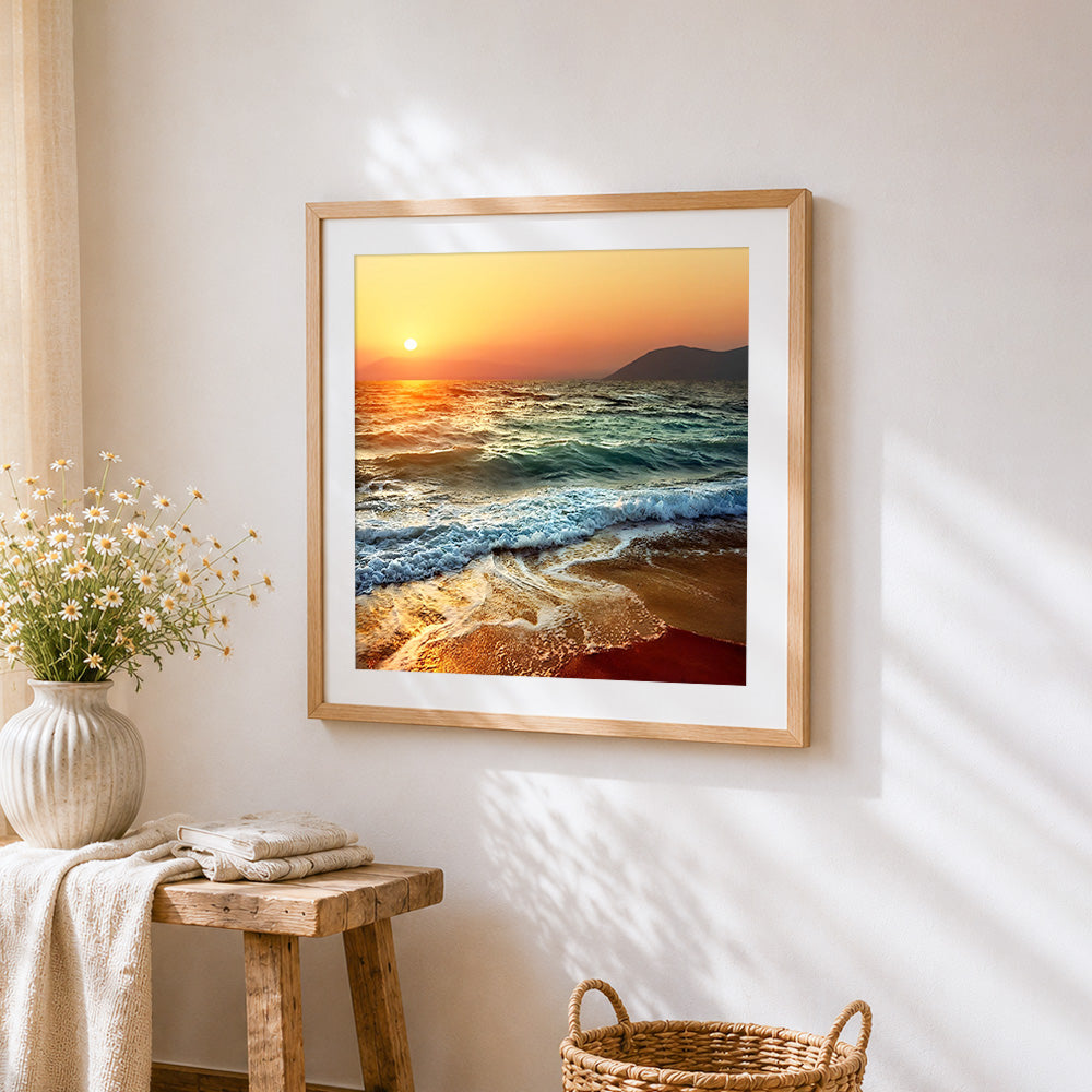 Ocean waves at sunset cross stitch artwork displayed on wall as home decor