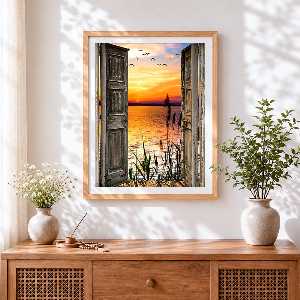 Finished open doors to a sunset lake and birds cross stitch artwork displayed