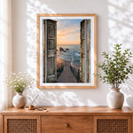 Finished open doors to a sunset ocean view paint by numbers artwork displayed as home decor