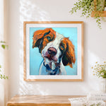 Finished orange and white hunting dog cross stitch artwork displayed