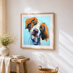 Orange and white hunting dog cross stitch artwork displayed on wall as home decor