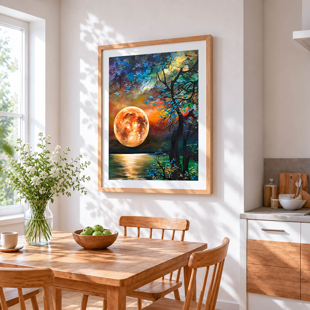 Orange moon and silhouette tree cross stitch artwork displayed on wall as home decor