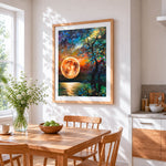 Orange moon and silhouette tree cross stitch artwork displayed on wall as home decor