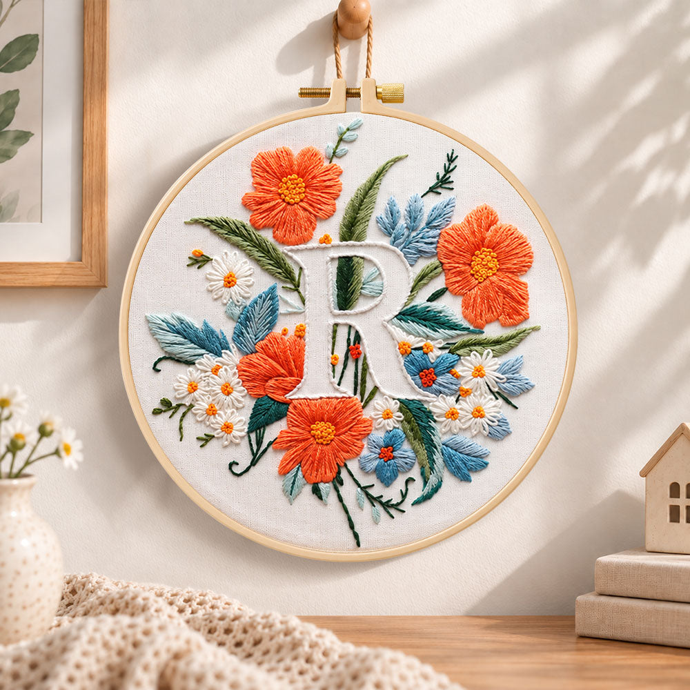 Orange poppies and letter r embroidery hoop wall art displayed as warm and cosy handmade home decor