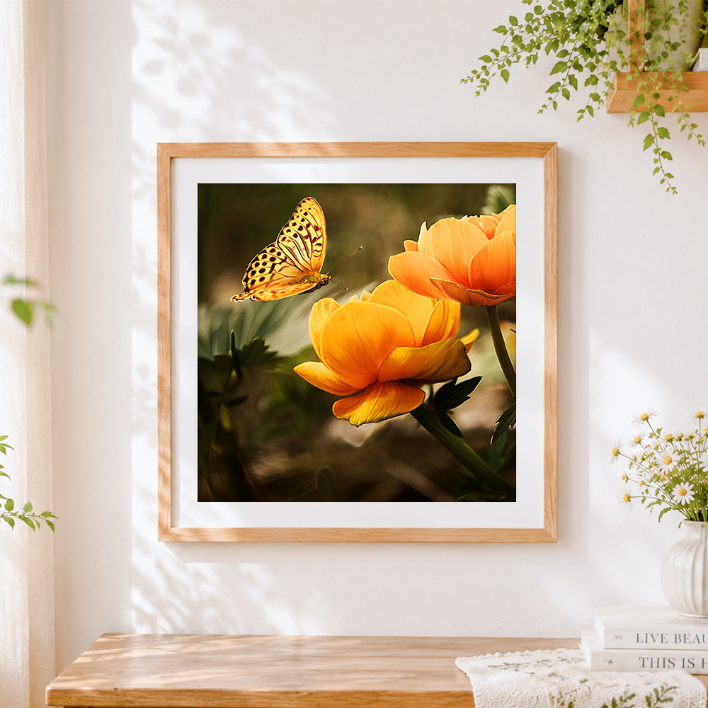 Finished orange ranunculus and butterfly cross stitch artwork displayed