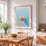 Orange starfish in ocean waves paint by numbers artwork displayed on wall as home decor