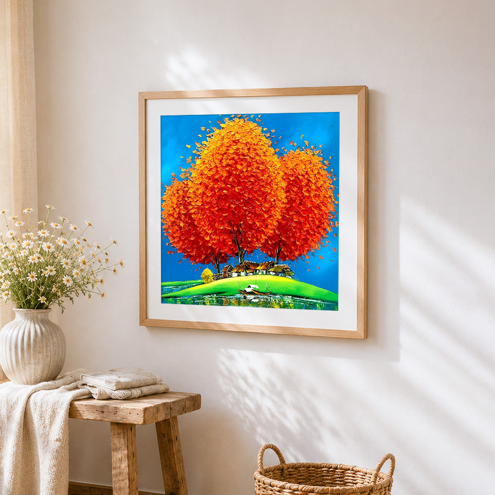 Orange tree and lakeside village cross stitch artwork displayed on wall as home decor