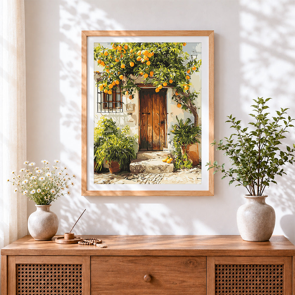 Finished orange tree and rustic wooden door cross stitch artwork displayed
