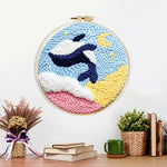 Finished orca and moon artwork displayed on a wall