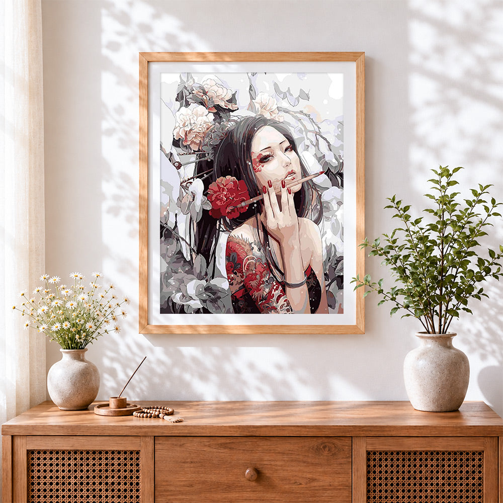Finished oriental woman with tattoos and flowers cross stitch artwork displayed