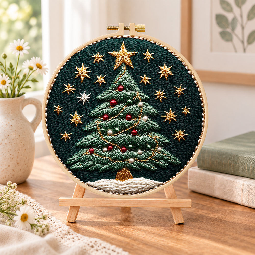 Ornamented christmas tree embroidery kit finished hoop displayed on a wooden stand as cosy tabletop decor