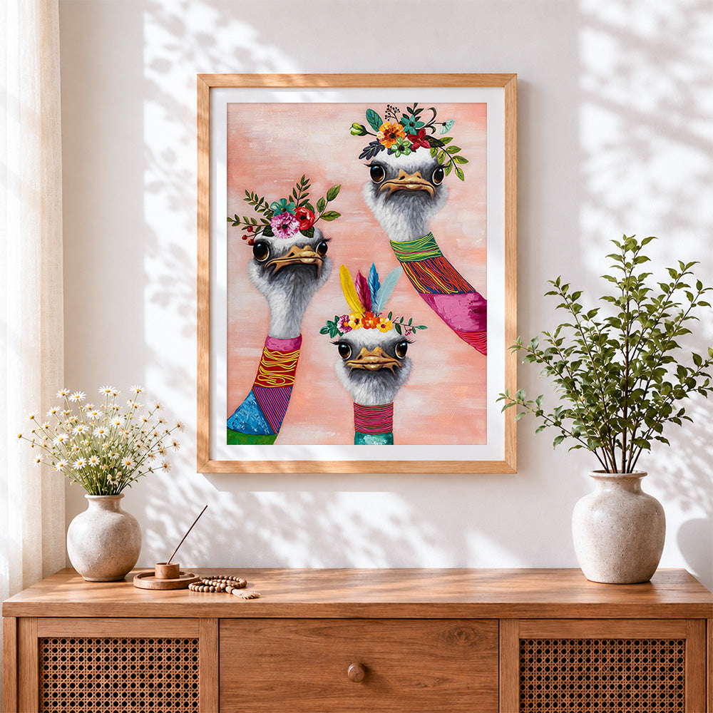 Finished ostriches with flower crowns cross stitch artwork displayed