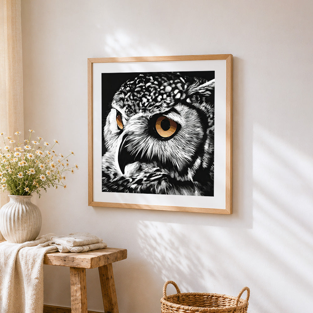Owl eye close-up cross stitch artwork displayed on wall as home decor