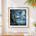 Finished owl flying over gothic castle cross stitch artwork displayed