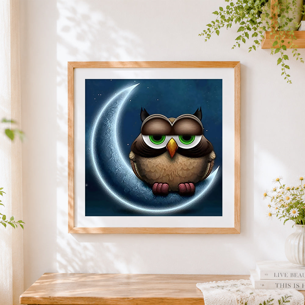 Finished owl on crescent moon cross stitch artwork displayed