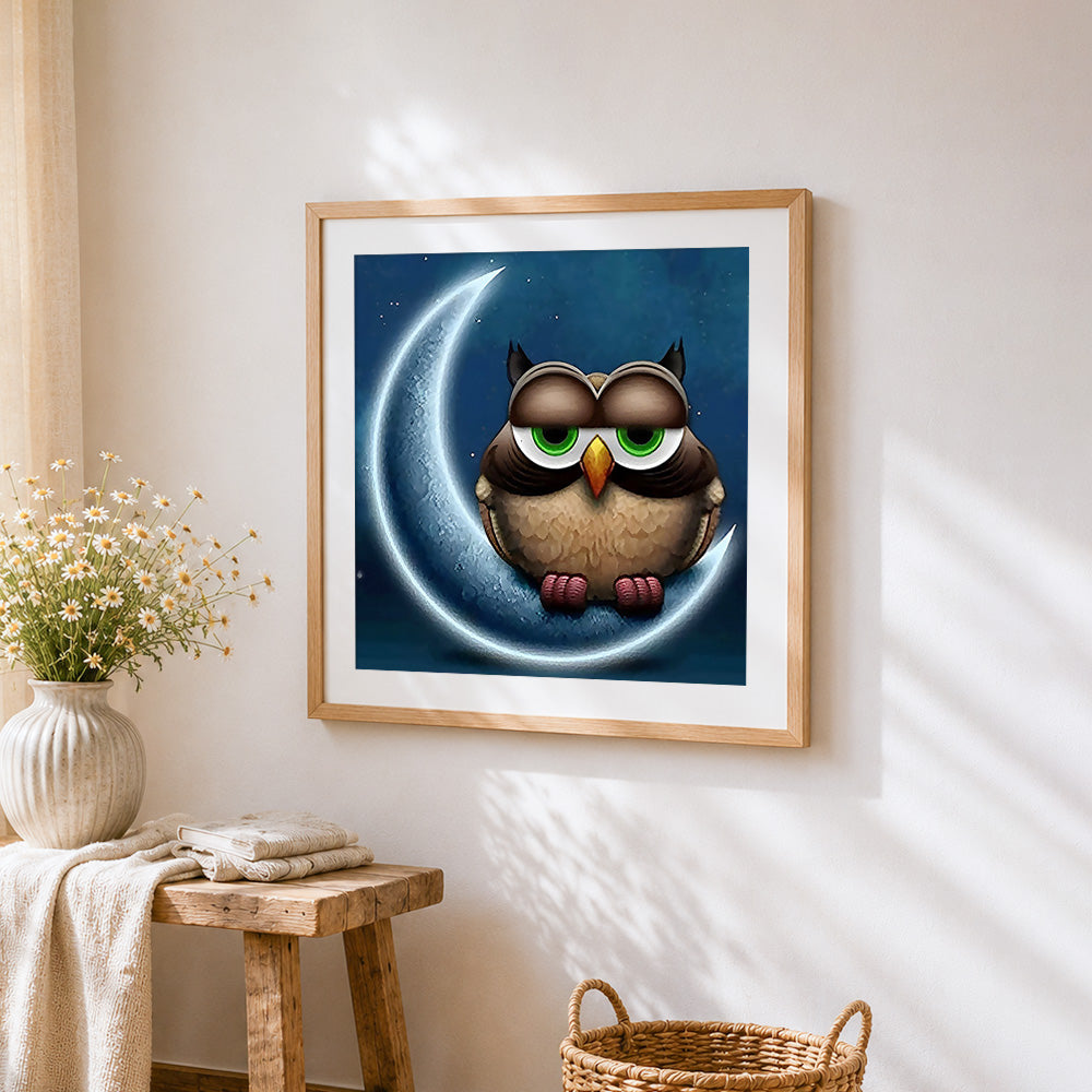 Owl on crescent moon cross stitch artwork displayed on wall as home decor