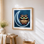 Owl on crescent moon cross stitch artwork displayed on wall as home decor