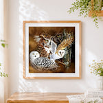 Finished owl species collage cross stitch artwork displayed