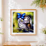 Finished owl with blue butterfly cross stitch artwork displayed