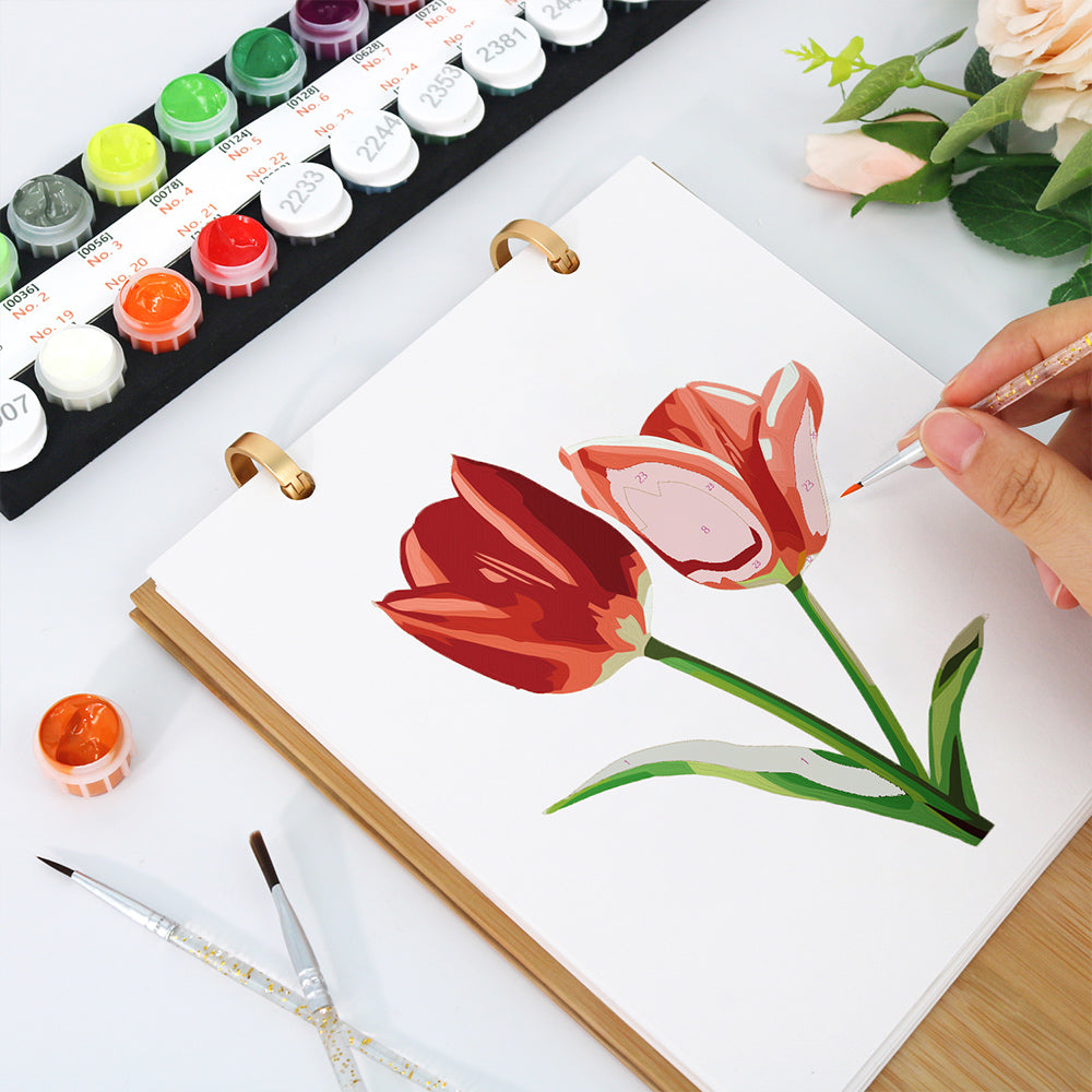 Close-up of painting red tulips on the Floral Blooms Paint by Numbers Calendar with paints and brushes