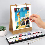 Hand painting a colourful Antibes seaside illustration on the Scenic Getaways Paint by Numbers Desk Calendar