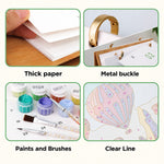 Close-up details of thick paper, gold metal binder rings, numbered paints, brushes and printed painting outlines