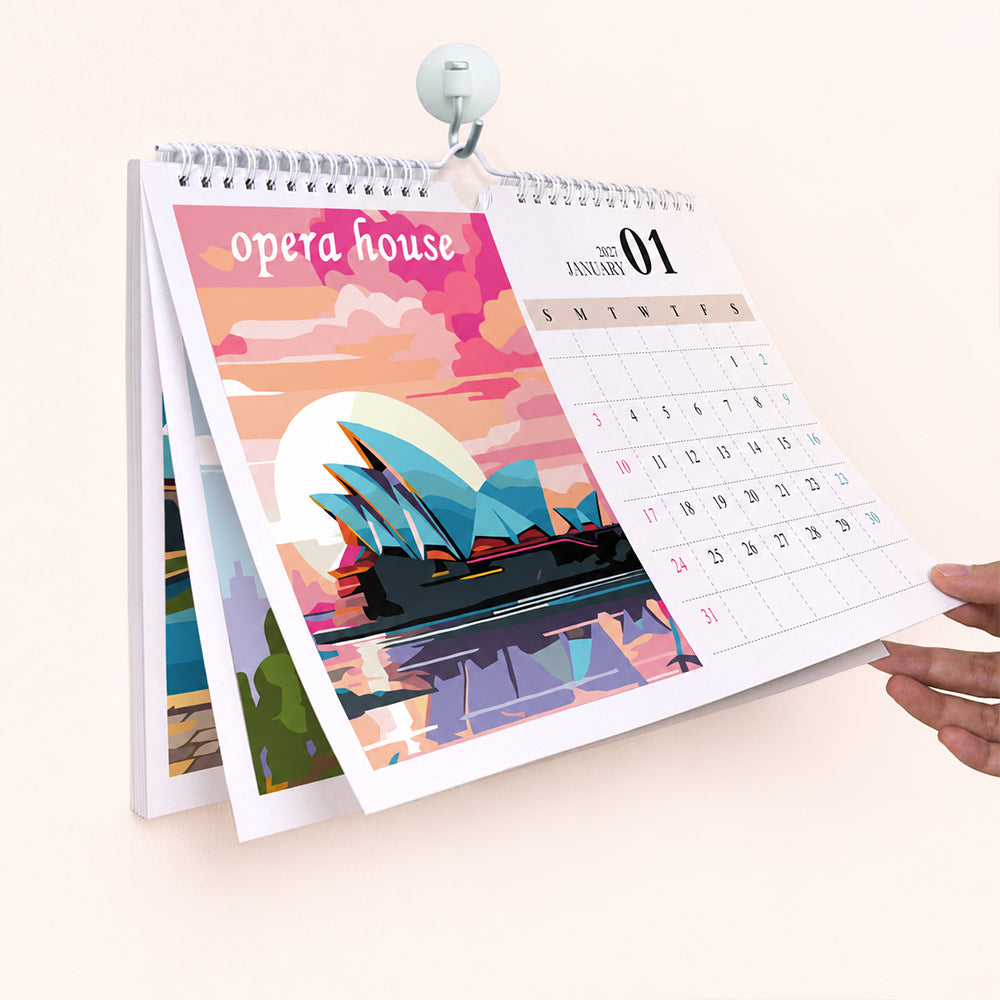 Hand flipping the January page featuring the Sydney Opera House in the Around the World Paint by Numbers Calendar