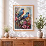 Finished pair of bluebirds on blossoming branch cross stitch artwork displayed