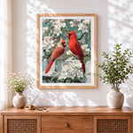 Finished pair of cardinals on blossom branch cross stitch artwork displayed